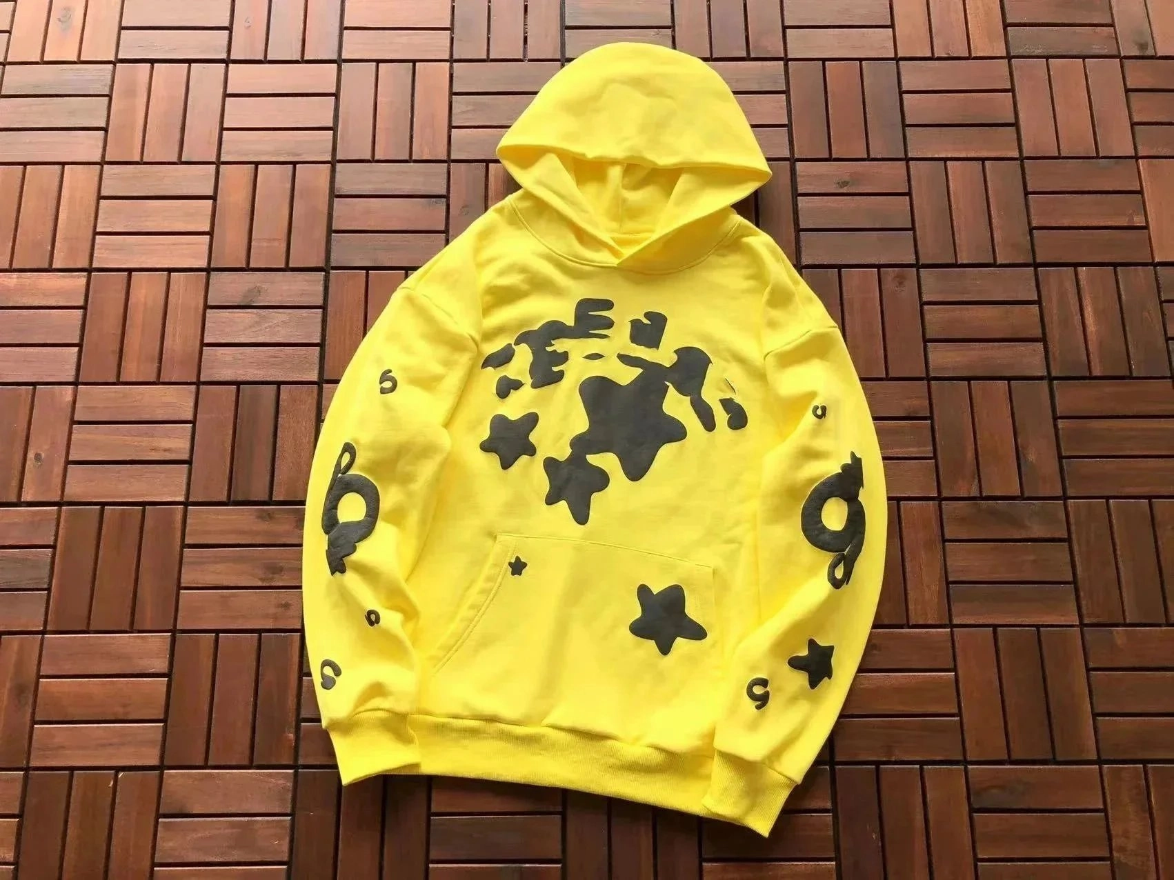 Vibrant Yellow Hoodie with Black Abstract Star Pattern