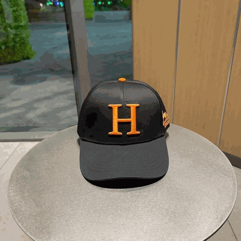 Herm&egrave;s Black Trucker Cap with Orange 'H' Logo and Lion Patch